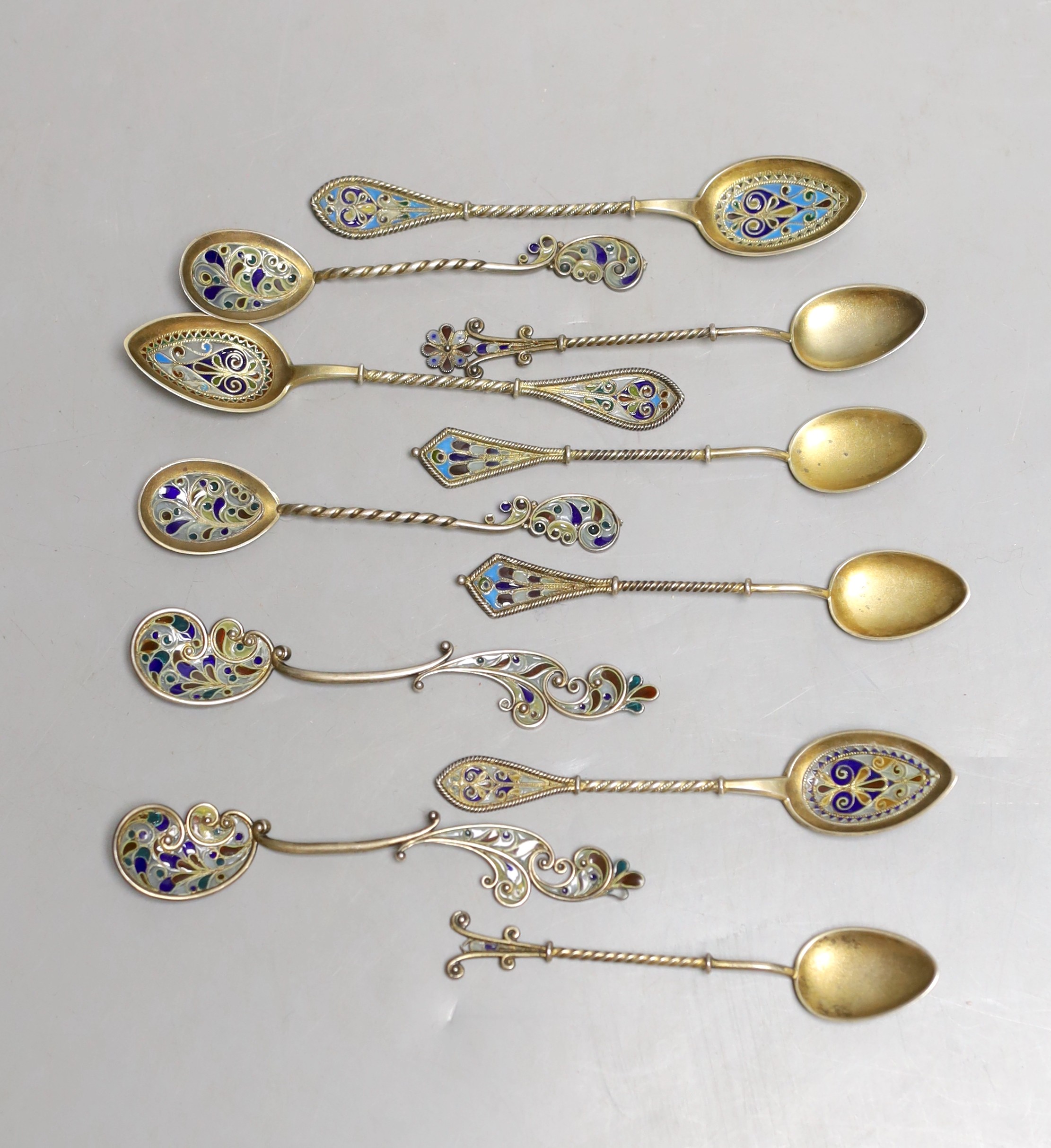 A small collection of eleven assorted Scandinavian gilt white metal and plique a jour small spoons, including four pairs, longest 11.8cm.